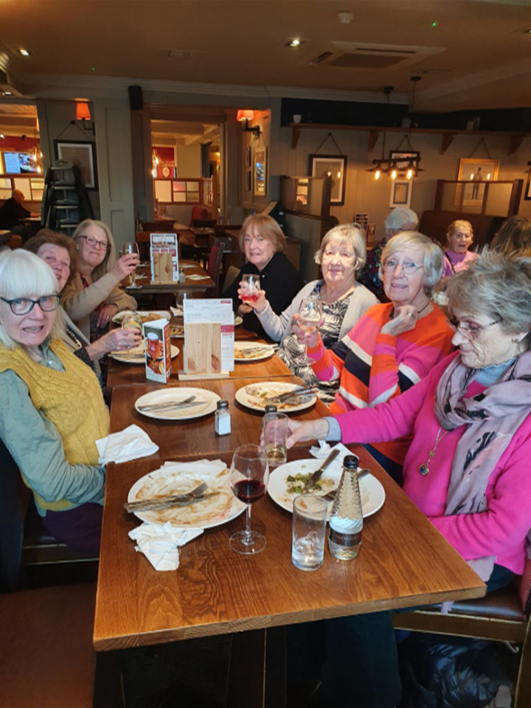 Rummikub group enjoying a meal